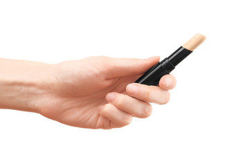 Female hand holding concealer pencil, isolated on white