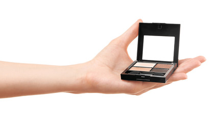 Female hand holding eye shadow, isolated on white