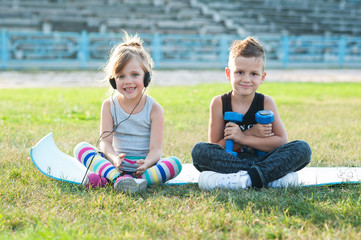 boy and girl doing exercises at the stadium