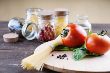 Red tomatoes on a cutting board and pasta