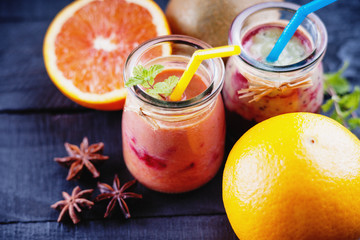 Jars with smoothies and fruits