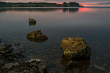 Stone in the water at sunset background