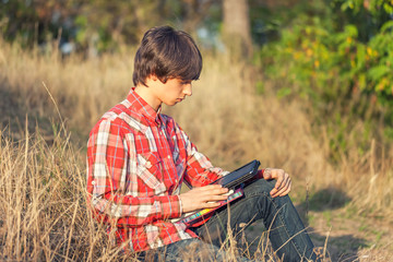 Young student working in city park