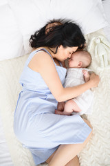 Loving mother caring for her baby girl