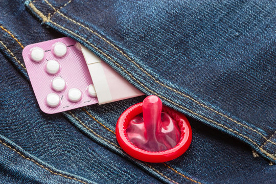 Pills and condom in denim pocket.
