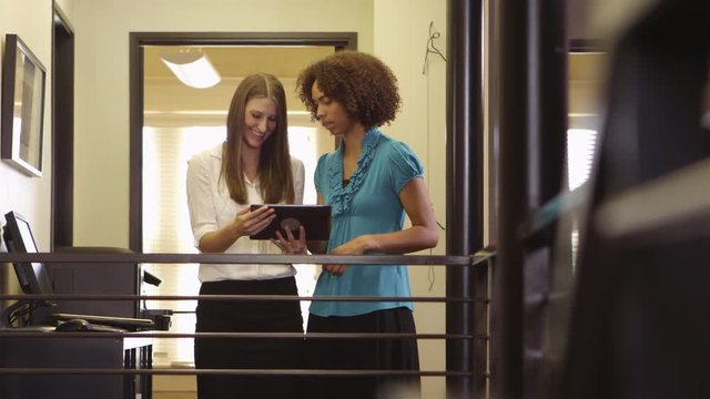 Two coworkers working on tablet