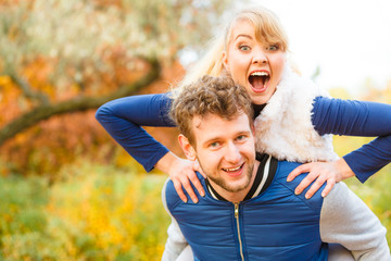 Man giving piggyback ride to woman in park