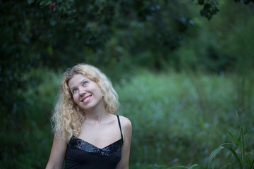 Beautiful blonde thinking in the park.