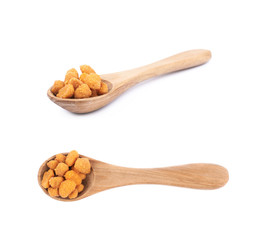 Spoon filled with the breaded peanuts
