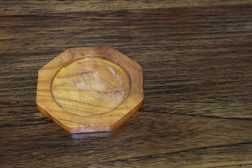 one wooden coaster on wooden table