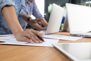 Fototapeta premium Business man hand pointing at business document during discussion at meeting