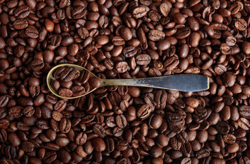 Coffee beans background and a spoon