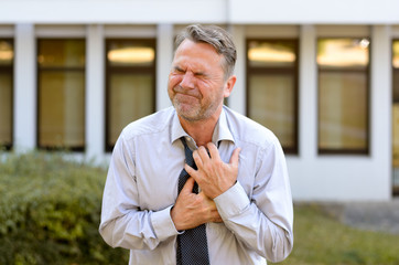Middle-aged businessman suffering chest pains
