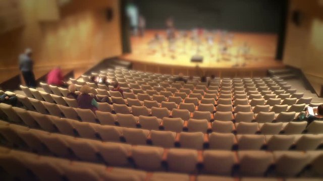 audience filling up theatre hall