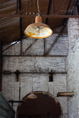 old rusty lamp hanging in an abandoned factory