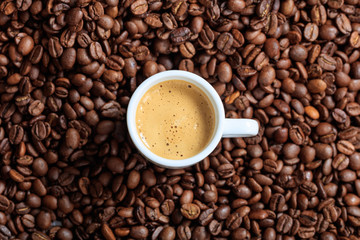 Cup of coffee on coffee beans background