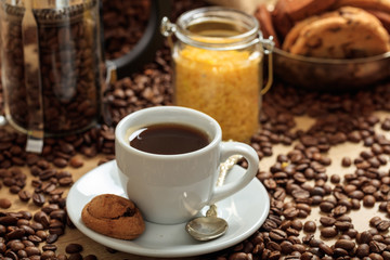 Coffee beans out of a sack and a cup of coffee