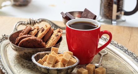 A cup of coffee on an old tray