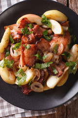 Fried bacon with onion and stewed green apples close up. vertical top view
