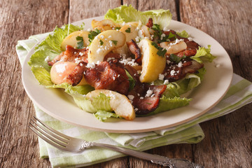 Scandinavian salad with fried bacon, onion, stewed apple and goat cheese close-up. horizontal
