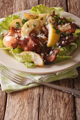 Delicious salad with fried bacon, onion, stewed apple and goat cheese. vertical
