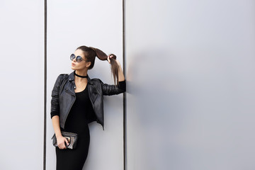 Fashion portrait of young elegant brunette woman outdoor.