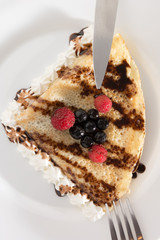 Fresh, golden pancakes with fruit and cream