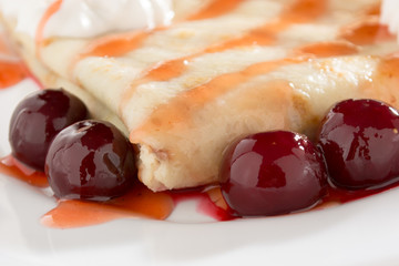 Fresh, golden pancakes with fruit and cream