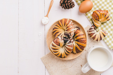 Breakfast with chocolate croissants on white table