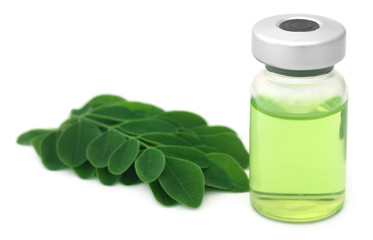 Moringa leaves with extract in a vial