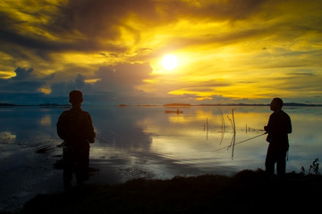 Beautiful sky and Silhouettes of fisherman.