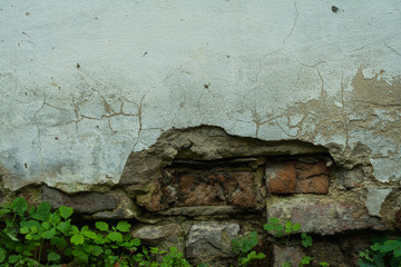 Old brick wall with plaster and decal