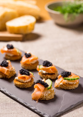 Obraz na płótnie Canvas Smoked Salmon Canapes with Sour Cream and Caviar