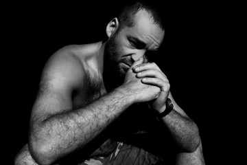 Handsome man sitting in the dark