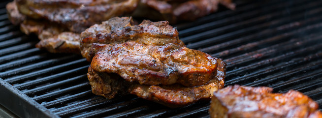 baked pork steak on bbq grill close-up