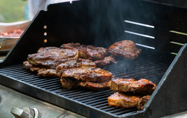 baked pork steak on bbq grill close-up