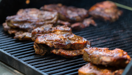 baked pork steak on bbq grill close-up