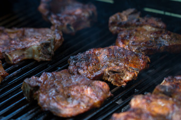 baked pork steak on bbq grill close-up