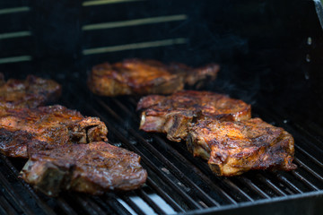 baked pork steak on bbq grill close-up