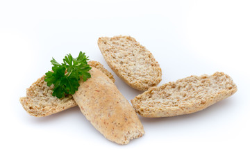 Dry flat bread crisps with herbs on a white background.
