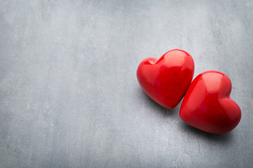 Red heart on the gray metal background.
