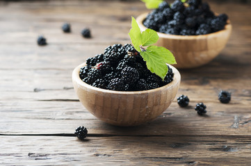 Sweet wild blackberry on the wooden table