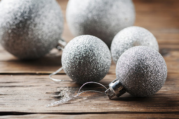 Christmas card with silver balls on the wooden table