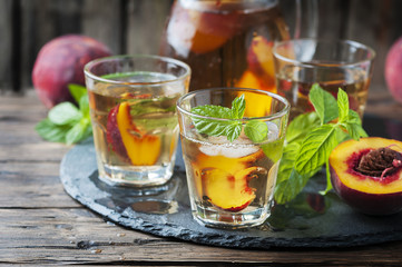 Cold healthy tea with peaches and mint