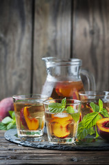 Cold healthy tea with peaches and mint
