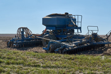 sowing complex of blue color is on the plowed field .close-up.
