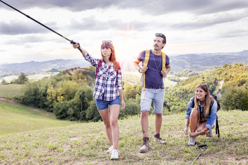 group of young hikers walking toward the horizon over the mounta