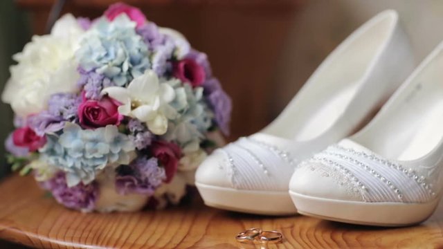 Wedding shoes rings bouquet of flowers