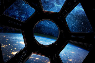 Earth and star in spaceship window porthole. Elements of this image furnished by NASA