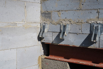 LOUTH, ENGLAND - AUGUST 26: Galvanised joist hangers within interior of house build in progress. In Louth, Lincolnshire, England. On 26th August 2016.